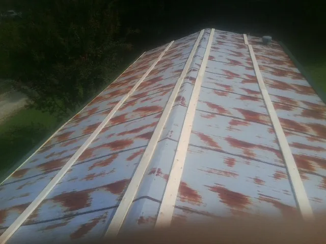 Rusted metal roof panels with new wood purlins before replacement — Storm Damage Roof Repair in Williams by Roofing Brothers